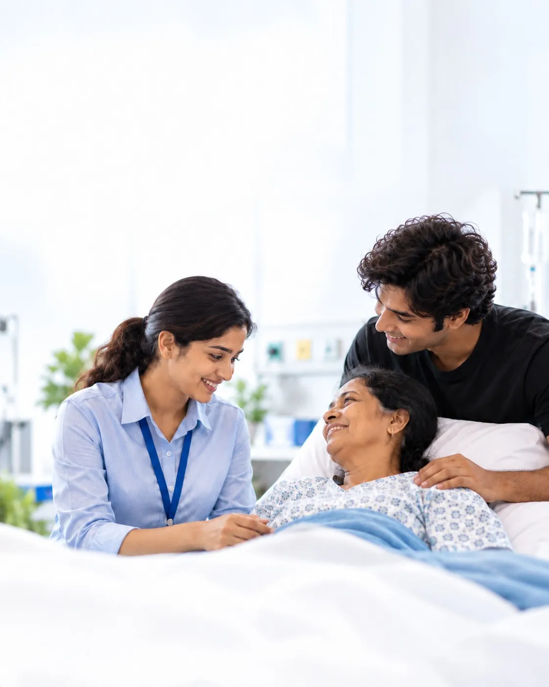 The mother smiling up at her son and the care coordinator from her hospital bed